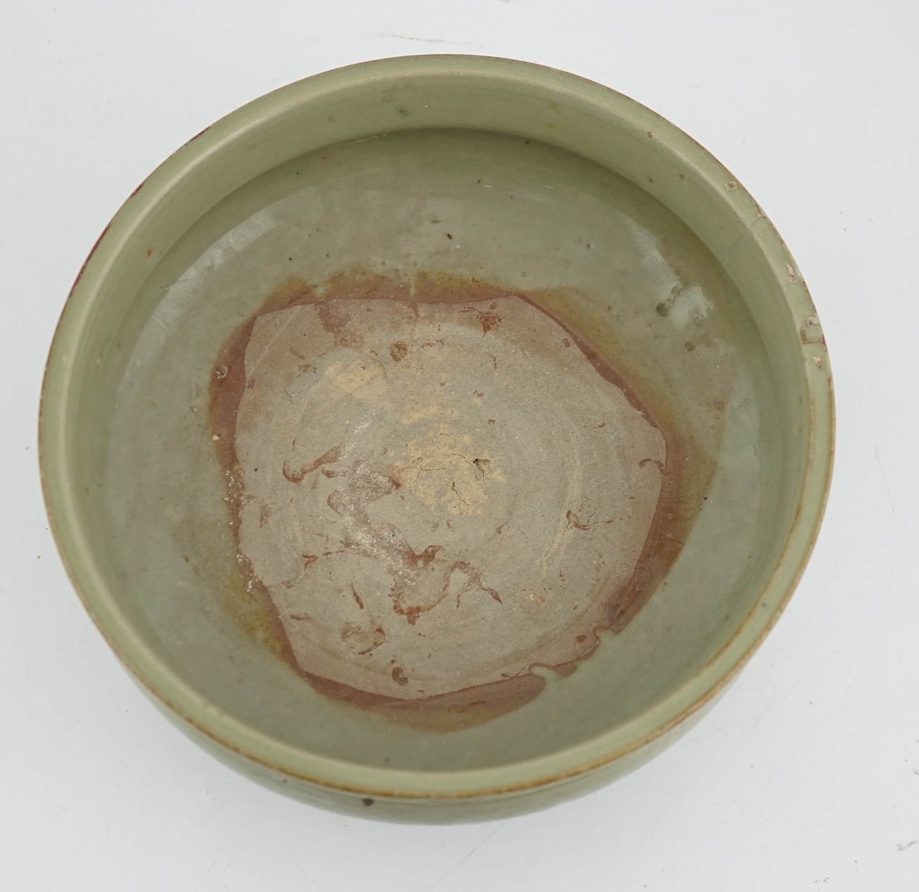 A Chinese Ming Longquan celadon tripod censer, 14th/15th century, some damage